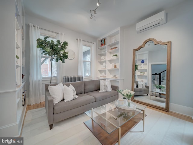 1234 Monroe St NE, Washington, DC 20017 - living area with baseboards, light wood finished floors, radiator, and a wall mounted air conditioner