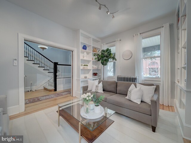 1234 Monroe St NE, Washington, DC 20017 - living room featuring stairway, light wood finished floors, baseboards, and radiator