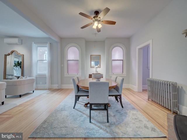 1234 Monroe St NE, Washington, DC 20017 - dining area with an AC wall unit, ceiling fan, radiator, and wood finished floors