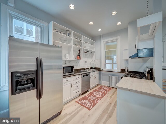 1234 Monroe St NE, Washington, DC 20017 - kitchen featuring white cabinets, open shelves, light wood finished floors, radiator, and stainless steel appliances