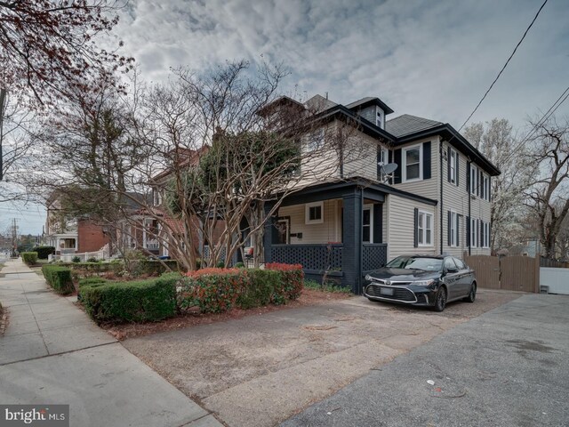 1234 Monroe St NE, Washington, DC 20017 - view of side of property featuring a porch and fence