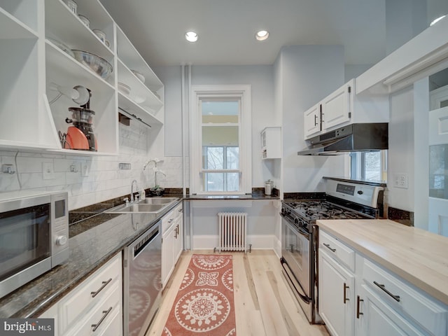 1234 Monroe St NE, Washington, DC 20017 - kitchen featuring open shelves, under cabinet range hood, white cabinetry, stainless steel appliances, and radiator heating unit
