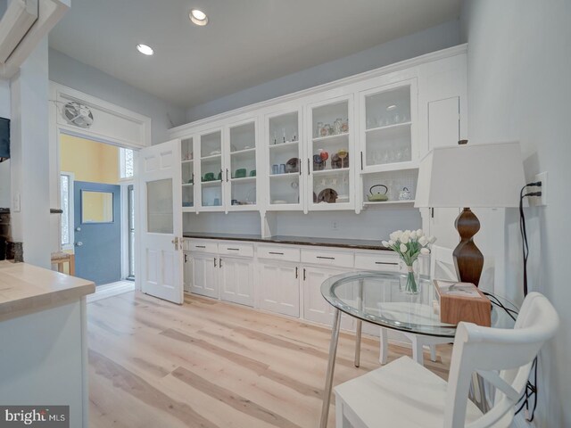 1234 Monroe St NE, Washington, DC 20017 - kitchen featuring light wood-type flooring, glass insert cabinets, white cabinets, and recessed lighting