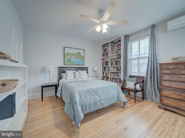 1234 Monroe St NE, Washington, DC 20017 - bedroom with light wood-style floors, a wall unit AC, and a ceiling fan