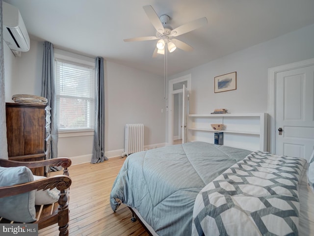 1234 Monroe St NE, Washington, DC 20017 - bedroom with baseboards, a ceiling fan, radiator, wood finished floors, and a wall unit AC