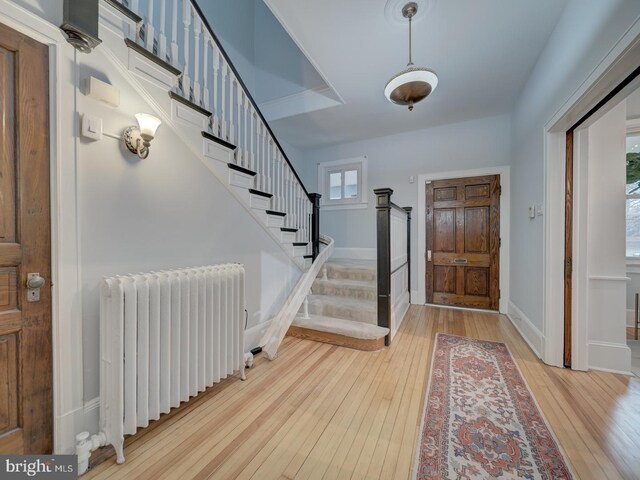 1234 Monroe St NE, Washington, DC 20017 - entrance foyer featuring radiator heating unit, stairway, hardwood / wood-style flooring, and baseboards