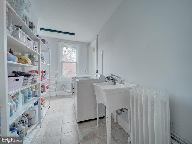 1234 Monroe St NE, Washington, DC 20017 - laundry area featuring laundry area, light tile patterned floors, radiator heating unit, washer and dryer, and baseboards