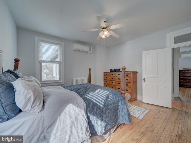 1234 Monroe St NE, Washington, DC 20017 - bedroom featuring light wood-type flooring, radiator, ceiling fan, and an AC wall unit