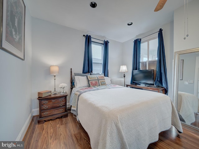 1234 Monroe St NE, Washington, DC 20017 - bedroom with ceiling fan, baseboards, radiator, and wood finished floors