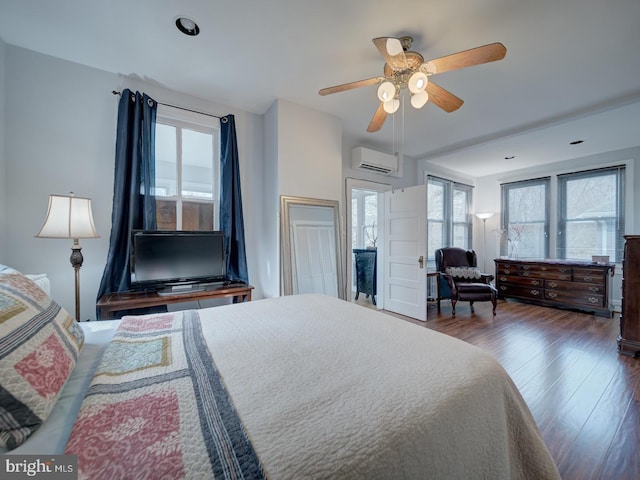 1234 Monroe St NE, Washington, DC 20017 - bedroom featuring a ceiling fan, a wall mounted AC, and wood finished floors