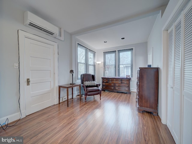 1234 Monroe St NE, Washington, DC 20017 - sitting room with a wall unit AC, wood finished floors, and baseboards