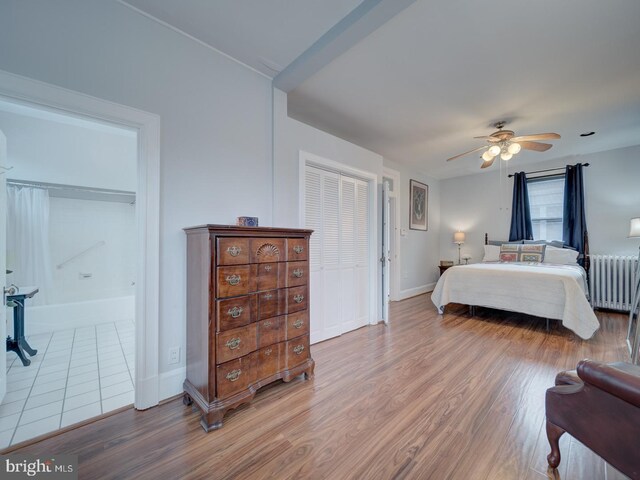 1234 Monroe St NE, Washington, DC 20017 - bedroom with radiator, wood finished floors, baseboards, and a ceiling fan