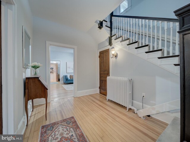 1234 Monroe St NE, Washington, DC 20017 - entrance foyer with light wood-style flooring, radiator, baseboards, and stairs