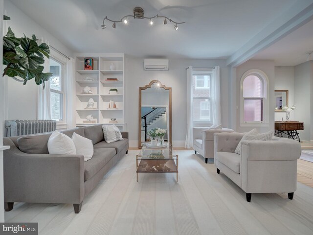 1234 Monroe St NE, Washington, DC 20017 - living area featuring radiator heating unit, stairs, baseboards, and a wall unit AC