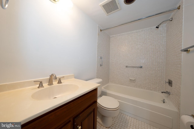 bathroom featuring toilet, tile patterned flooring, vanity, and  shower combination