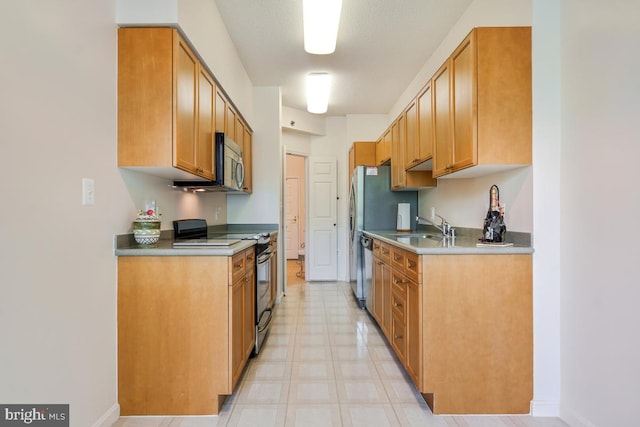 2901 S Leisure World Blvd Unit 133, Silver Spring, MD 20906 - kitchen featuring appliances with stainless steel finishes, a sink, light flooring, baseboards, and light countertops