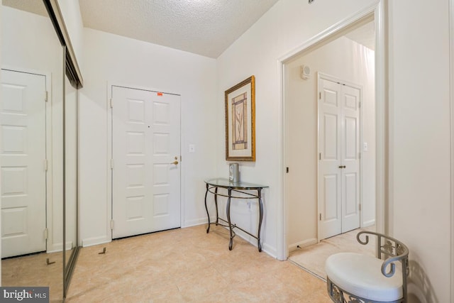 2901 S Leisure World Blvd Unit 133, Silver Spring, MD 20906 - foyer entrance featuring a textured ceiling and baseboards