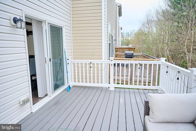 wooden deck featuring area for grilling