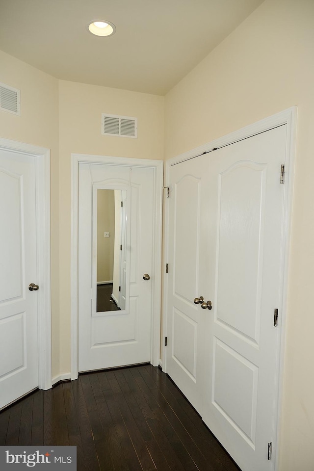 hall with recessed lighting, visible vents, and dark wood-style floors