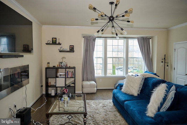 living room with a chandelier, baseboards, crown molding, and wood finished floors