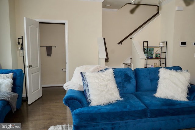 living room featuring ornamental molding, wood finished floors, and stairs
