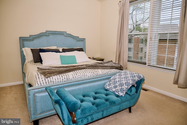 carpeted bedroom with visible vents and baseboards