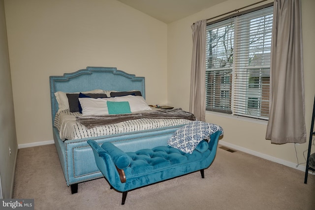 carpeted bedroom featuring visible vents, baseboards, and vaulted ceiling