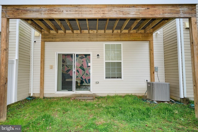 view of exterior entry featuring central AC unit