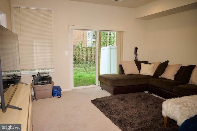 living area featuring carpet and visible vents