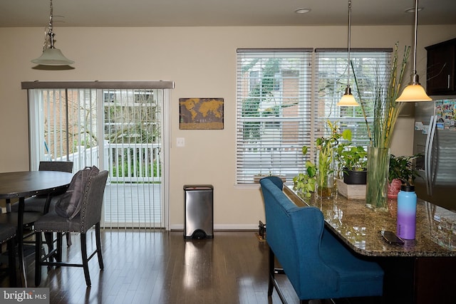 dining room featuring baseboards and dark wood finished floors