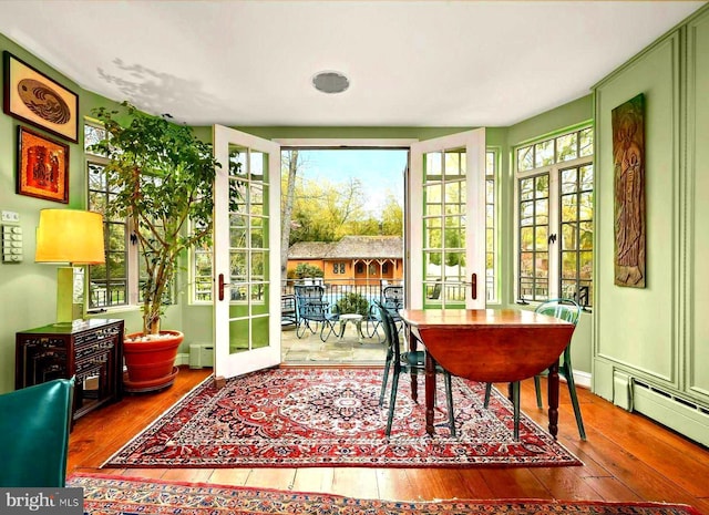 sunroom / solarium featuring french doors and baseboard heating