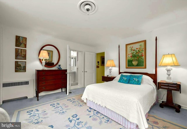 carpeted bedroom featuring radiator