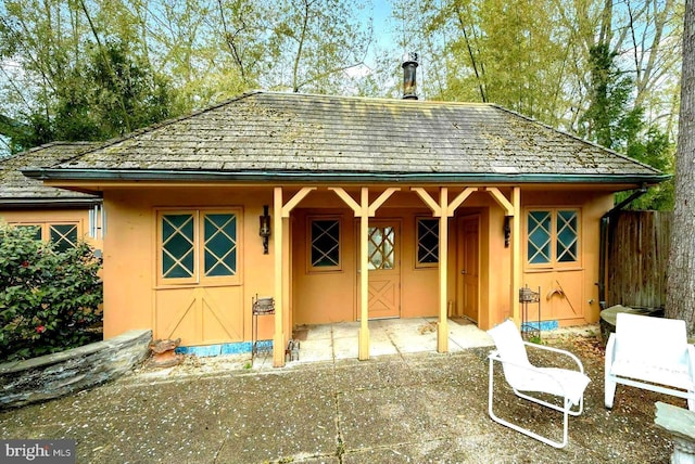 view of outbuilding with fence