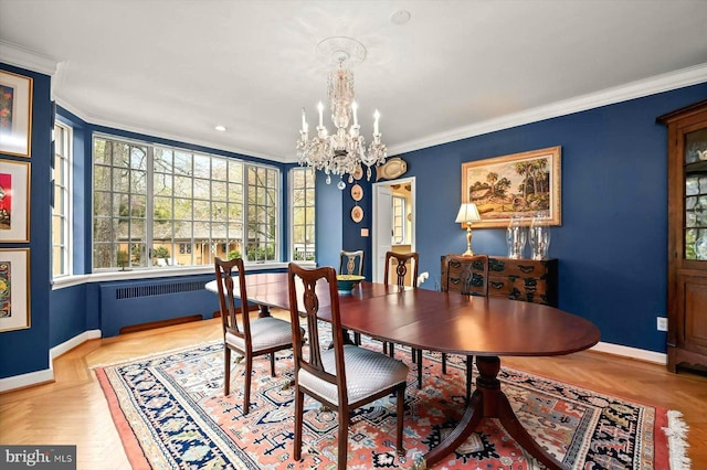 dining area featuring plenty of natural light, baseboards, a notable chandelier, radiator heating unit, and ornamental molding