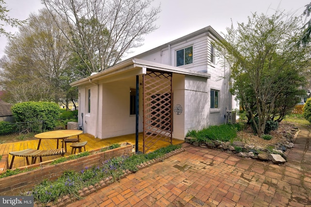 27 Ridge Rd, Greenbelt, MD 20770 - view of side of property with a patio area, concrete block siding, and fence