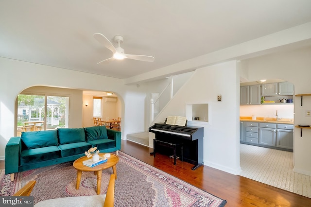 27 Ridge Rd, Greenbelt, MD 20770 - living room featuring baseboards, stairway, ceiling fan, arched walkways, and wood finished floors