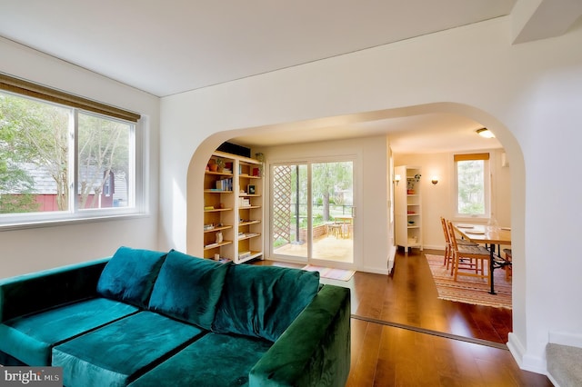 27 Ridge Rd, Greenbelt, MD 20770 - living room with arched walkways, wood-type flooring, baseboards, and built in features