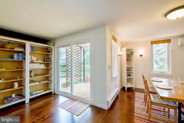 27 Ridge Rd, Greenbelt, MD 20770 - dining area with baseboard heating, baseboards, dark wood finished floors, and an AC wall unit