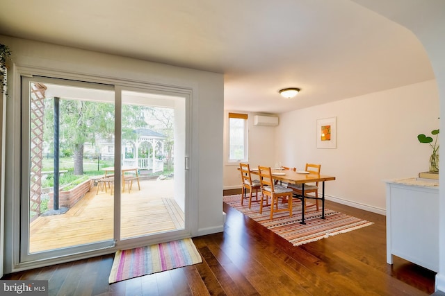 27 Ridge Rd, Greenbelt, MD 20770 - dining area featuring a wall mounted AC, dark wood-type flooring, and baseboards