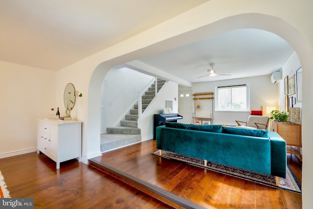 27 Ridge Rd, Greenbelt, MD 20770 - living room with arched walkways, a ceiling fan, wood finished floors, stairs, and a wall unit AC