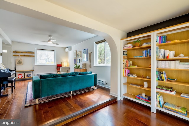 27 Ridge Rd, Greenbelt, MD 20770 - living area featuring a baseboard radiator, ceiling fan, an AC wall unit, and hardwood / wood-style flooring