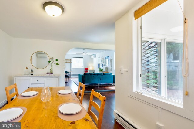27 Ridge Rd, Greenbelt, MD 20770 - dining space with arched walkways, baseboard heating, dark wood-style flooring, and a ceiling fan