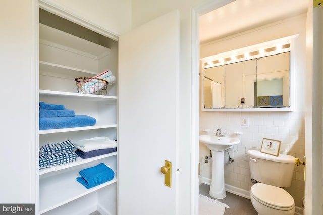 27 Ridge Rd, Greenbelt, MD 20770 - bathroom with tile walls, a sink, and toilet