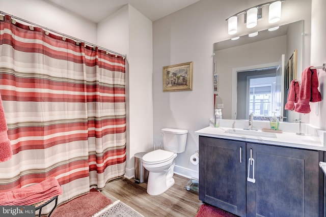 104 Saint Ives Pl Unit 409, Oxon Hill, MD 20745 - bathroom featuring vanity, toilet, curtained shower, wood finished floors, and baseboards