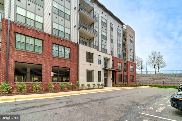 104 Saint Ives Pl Unit 409, Oxon Hill, MD 20745 - view of building exterior featuring uncovered parking
