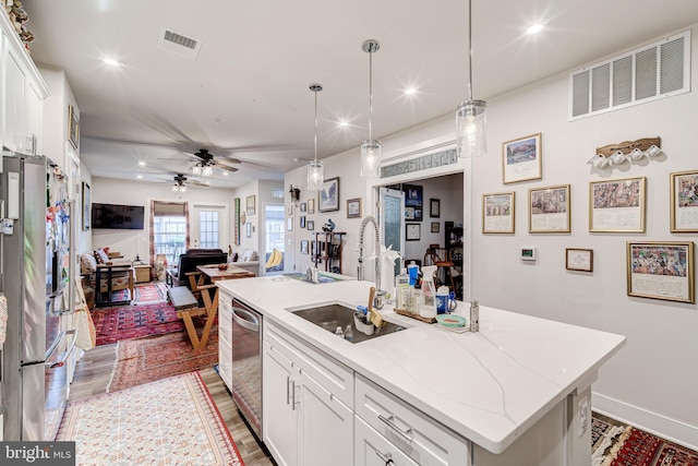 104 Saint Ives Pl Unit 409, Oxon Hill, MD 20745 - kitchen with an island with sink, visible vents, a sink, and appliances with stainless steel finishes