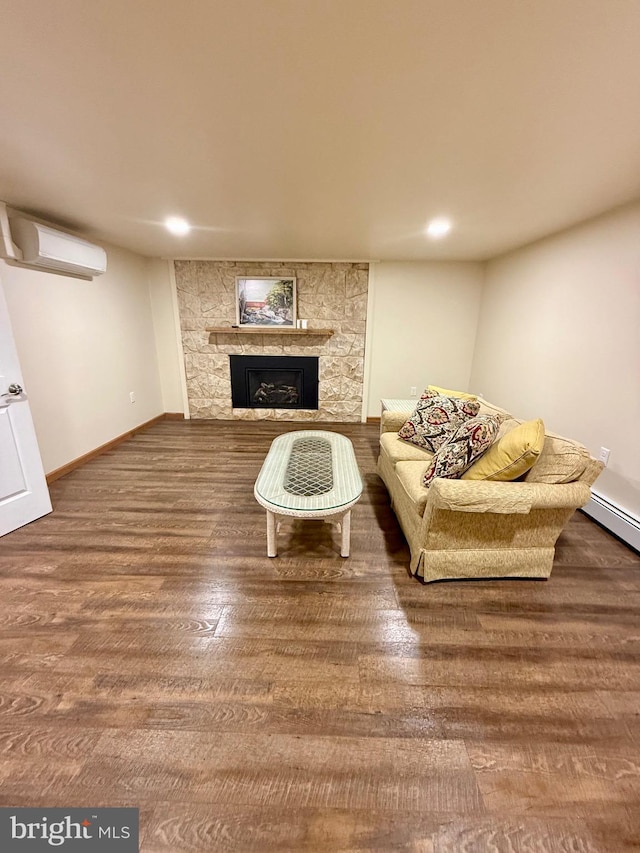 11003 Marty St NW, Lavale, MD 21502 - living room featuring a wall mounted AC, a fireplace, wood finished floors, recessed lighting, and baseboards