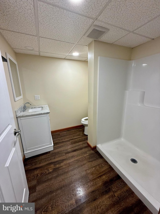 11003 Marty St NW, Lavale, MD 21502 - bathroom featuring a drop ceiling, toilet, vanity, wood finished floors, and baseboards