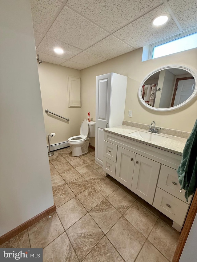 11003 Marty St NW, Lavale, MD 21502 - bathroom featuring a baseboard radiator, a drop ceiling, vanity, toilet, and baseboards