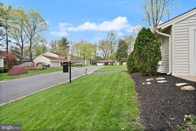 view of yard with a garage and a residential view